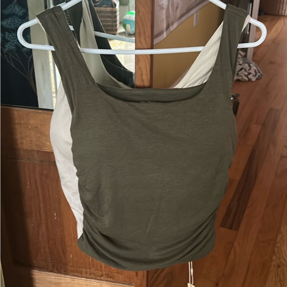 OGL Green and cream colored M sized tank tops